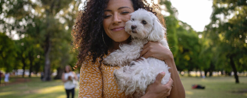 young-lady-cuddling-a-small-white-dog